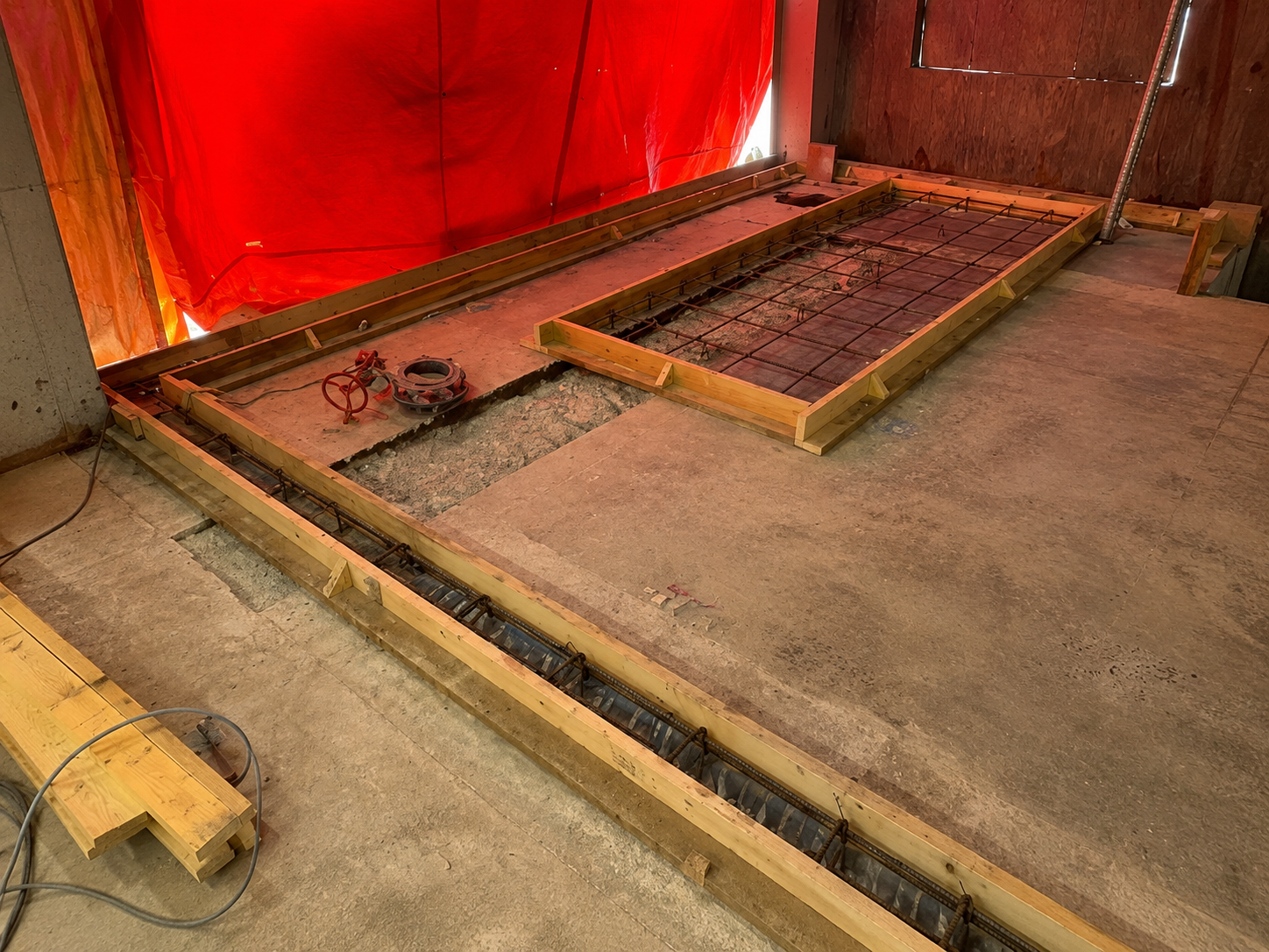 Completed concrete and service preparation work inside an industrial facility